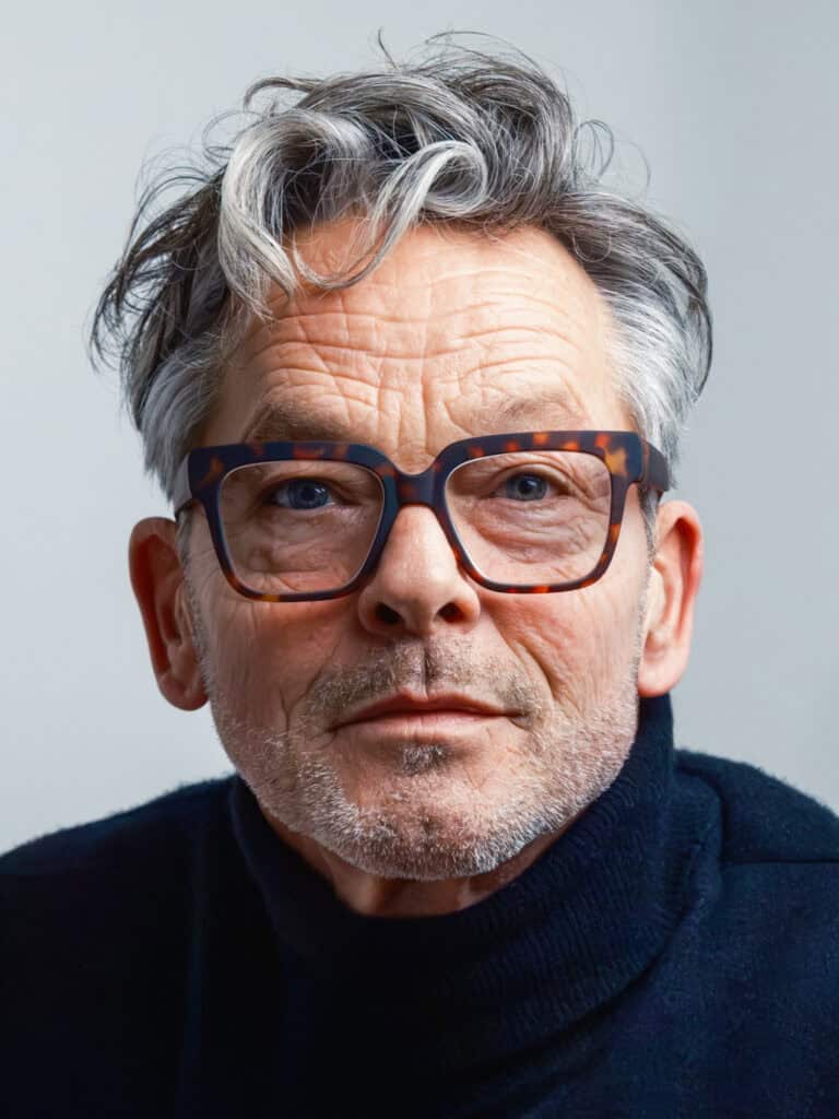 Portrait professionnel en couleur. portrait photographié par une femme. Il s'agit d'un gros plan d'un homme de 60 ans, avec des rides et portant des lunettes et un bleu.